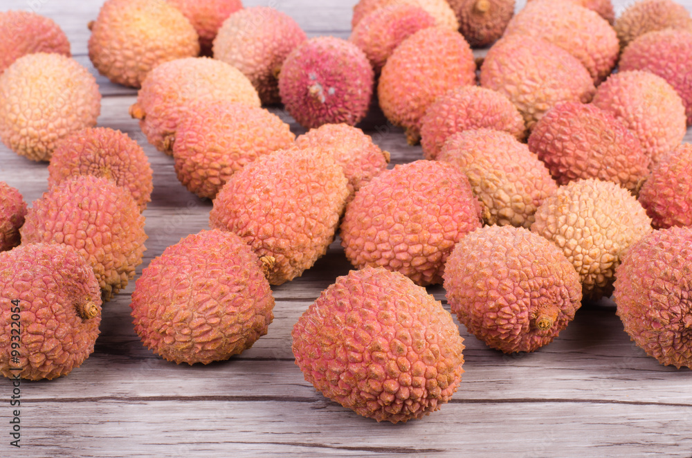 Tasty litchi exotic fruits on wooden background Tasty litchi exotic fruits on wooden background