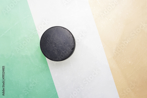 old hockey puck is on the ice with ireland flag