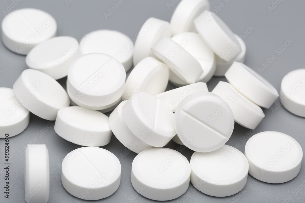Heap of white round tablets medical