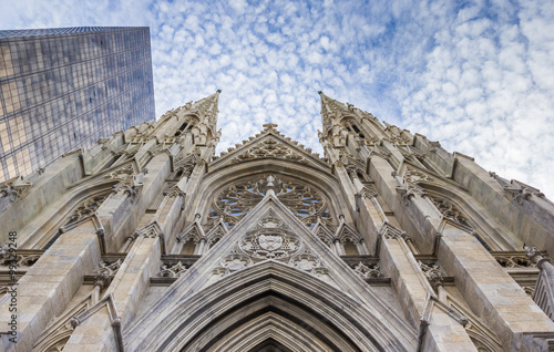 Front of St. Patricks Cathedral and a skyscraper in New York photo