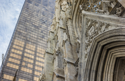 Front of St. Patricks Cathedral and a skyscraper in New York photo