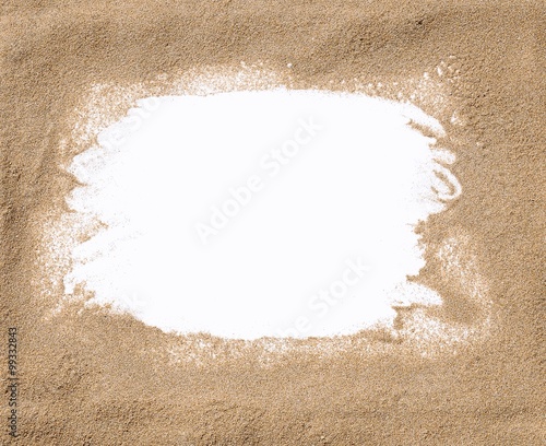 White frame surrounded by sand
