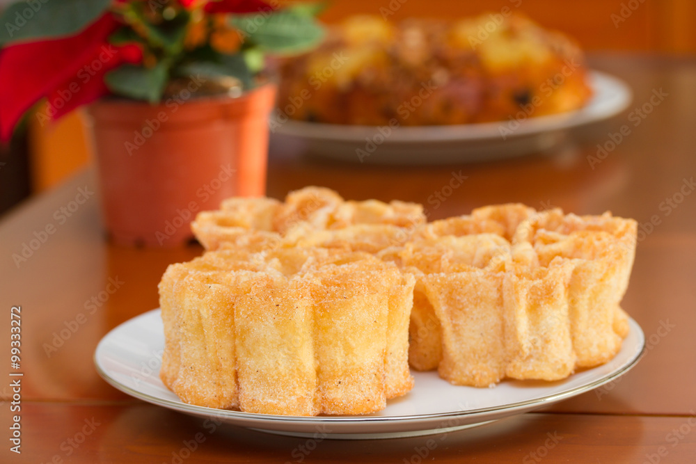 typical portuguese dessert filhos on white plate on brown background typical portuguese dessert filhos on white plate on brown background