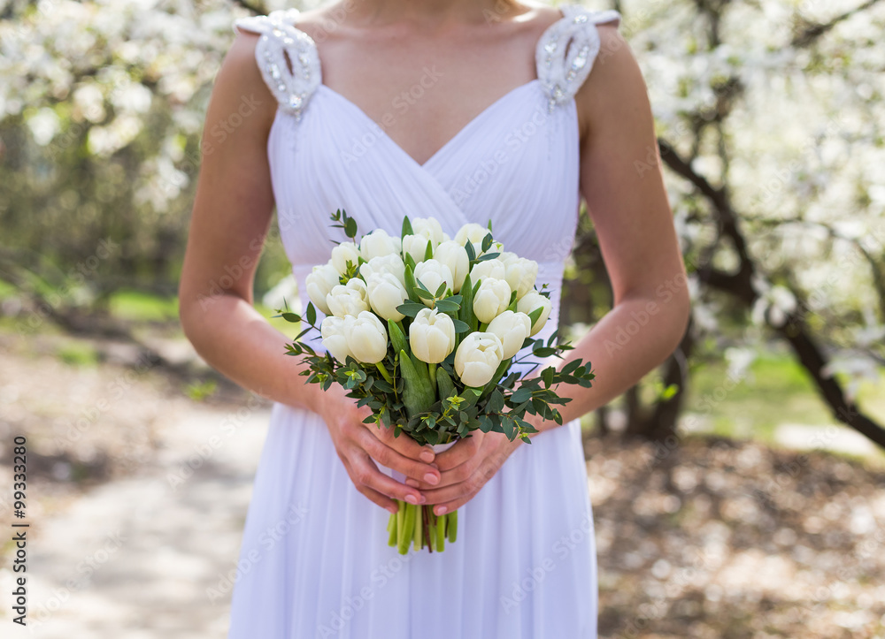 Happy Bride with bouquet in sunny wedding day