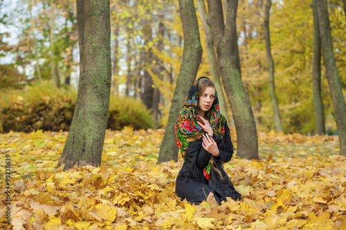 Young beautiful brunette woman posing outdoors in autumn park © Andrey_Arkusha