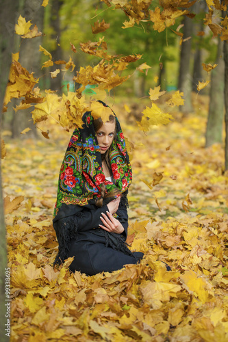 Young beautiful brunette woman posing outdoors in autumn park