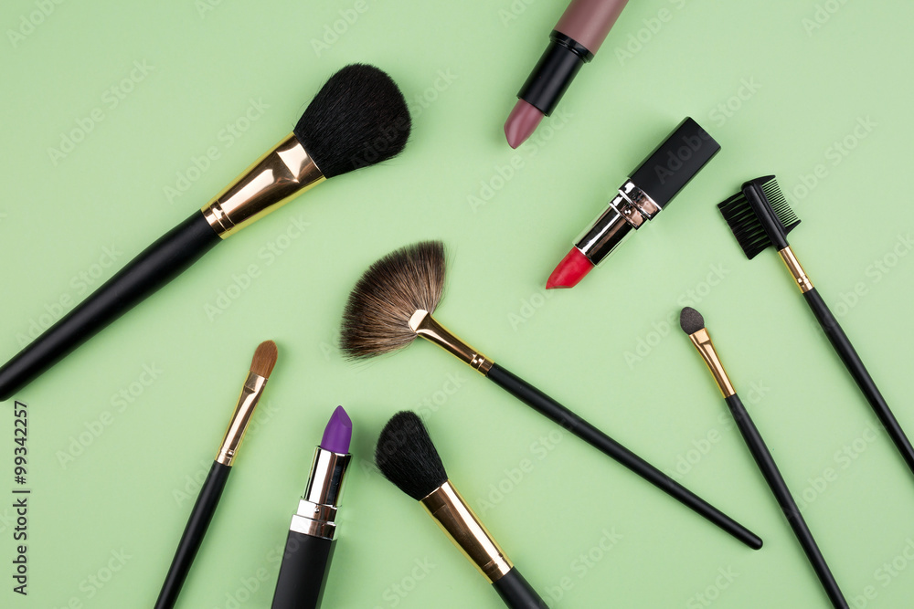 Different cosmetics on green background Different cosmetics on green background