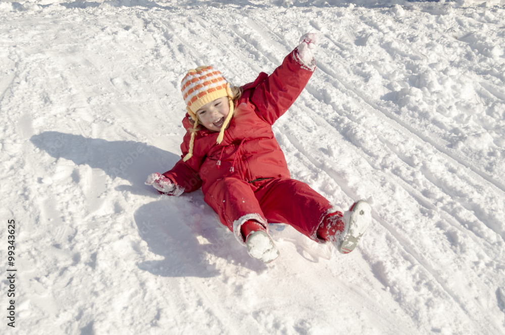 Little girl playing outdoors in snow