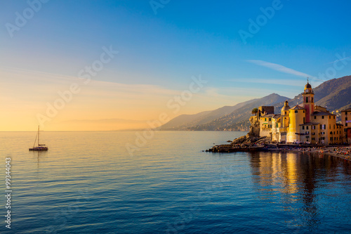 Mediterranean Sea at sunrise, small old town and yacht - photo