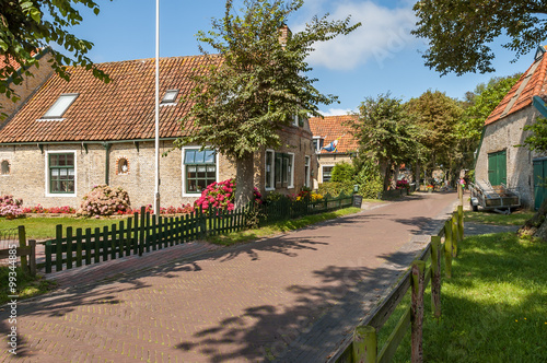 Street with old Dutch commander houses in the town of Hollum on the West-Frisian island Ameland, Netherlands photo