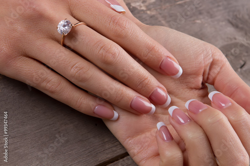 Ring with a diamond on a woman's finger.