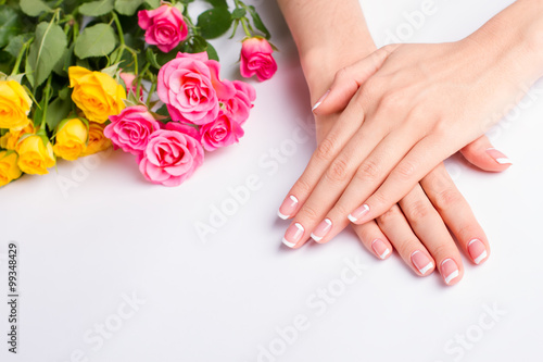 French manicure with pink and yellow roses on a white background