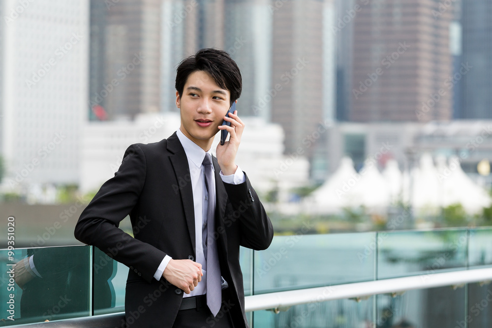 Businessman make a call and standing at outdoor Businessman make a call and standing at outdoor