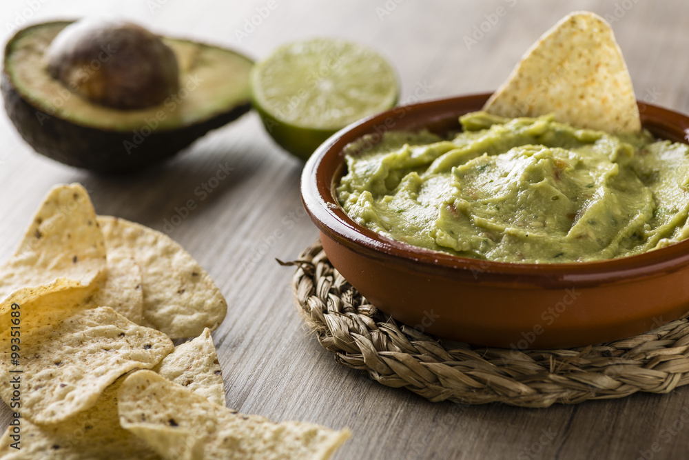 Guacamole with avocado, lime, tomato, and cilantro with tortilla