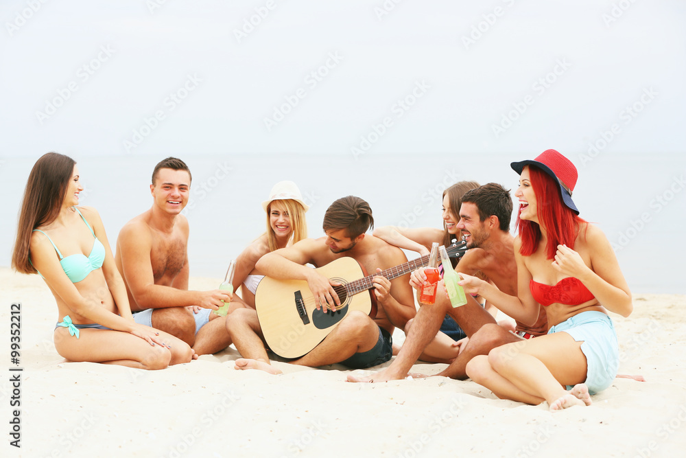 Beautiful young people with guitar having fun on beach Beautiful young people with guitar having fun on beach