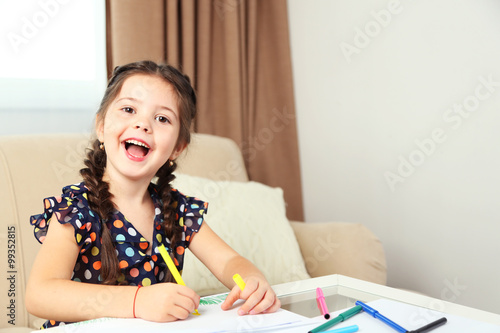 Cute little girl drawing pi...