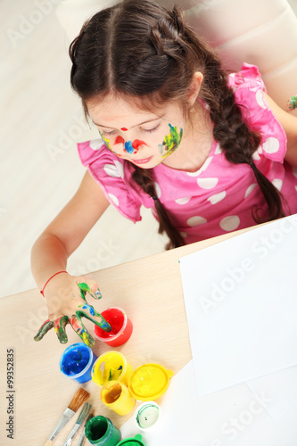 Cute little girl painting p...