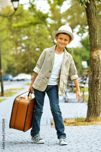 Little boy with suitcase in...