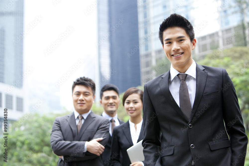 Cheerful businessman with his team in Hong Kong Cheerful businessman with his team in Hong Kong