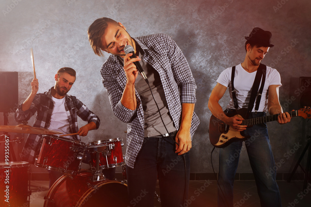 Fototapeta premium Musicians playing musical instruments and singing songs in a studio