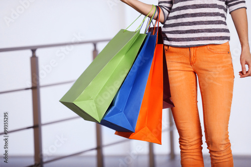 Young woman with shopping bags in the mall