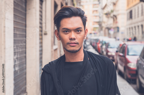Handsome Asian model posing in the city streets