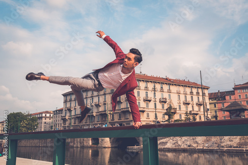 Handsome Asian model jumping in the city streets