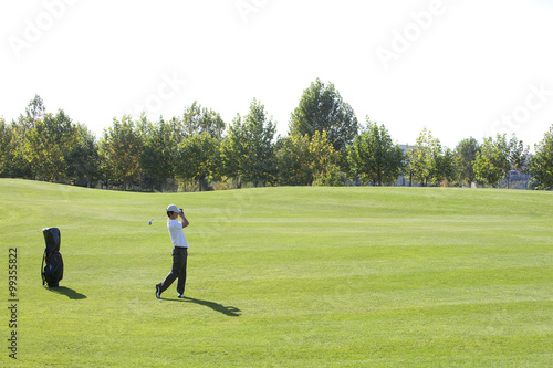 Young Man Taking a Golf Swing