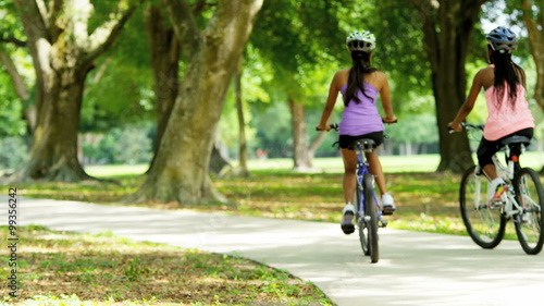 Wallpaper Mural Young multi ethnic fitness girls enjoying riding bikes outdoor Torontodigital.ca