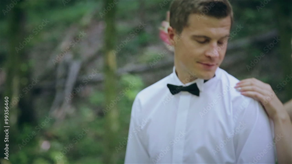 The bride kisses the groom in the forest The bride kisses the groom in the forest