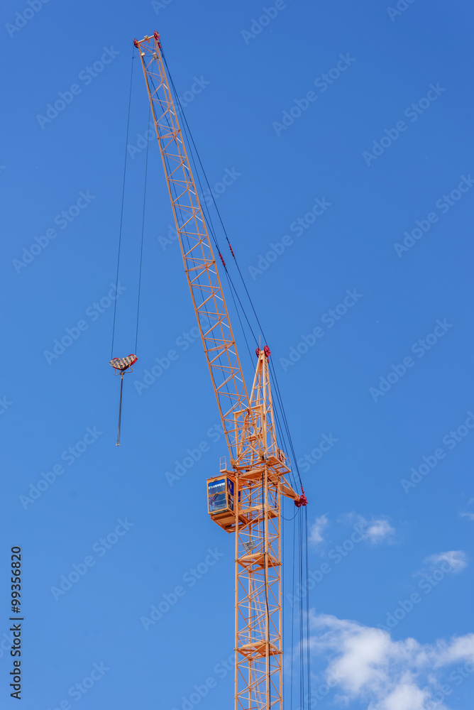 The site with cranes against blue sky The site with cranes against blue sky