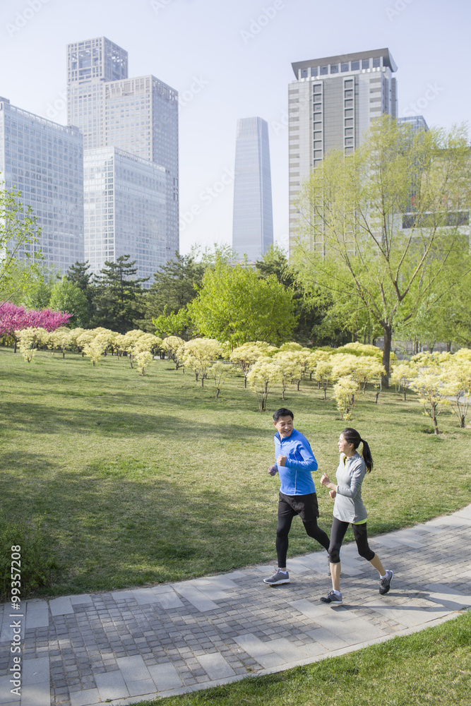 Happy mature couple running in park Happy mature couple running in park