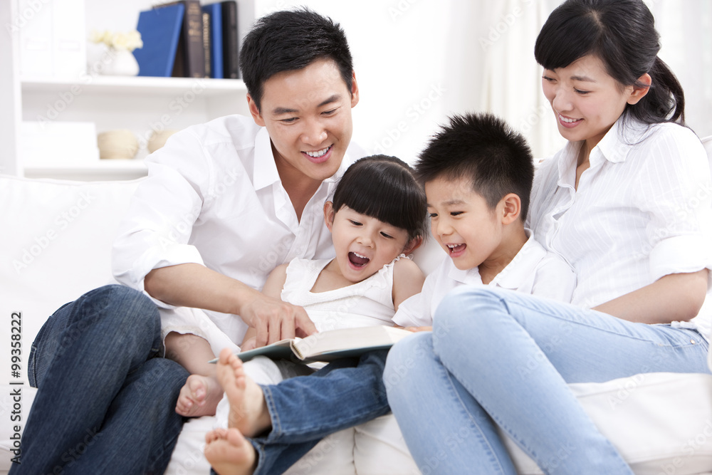 Happy family reading book in sofa Happy family reading book in sofa