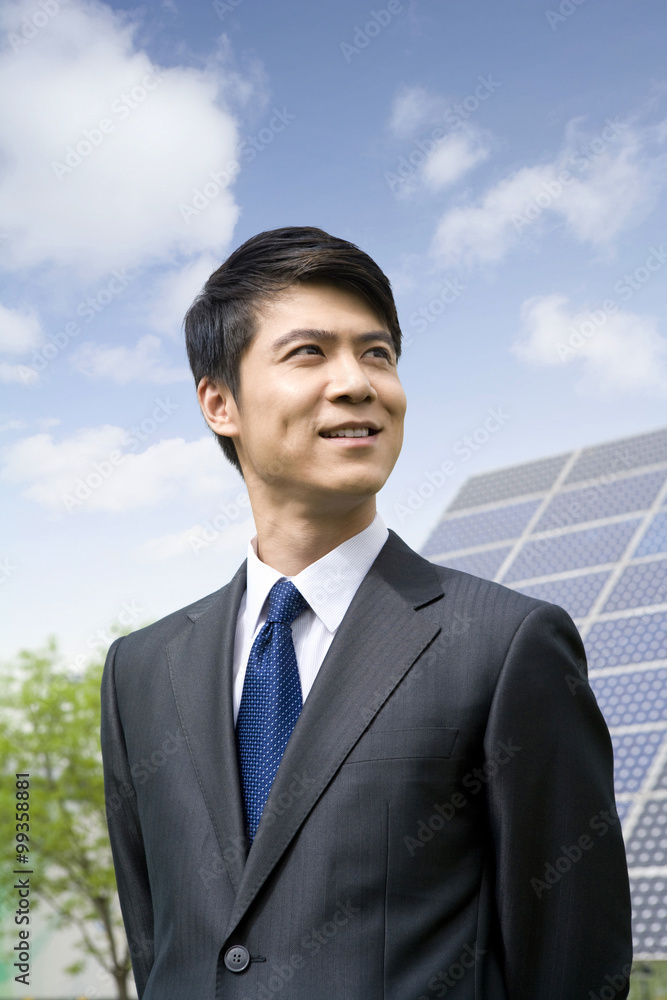 Portrait of a businessman in front of solar panels Portrait of a businessman in front of solar panels