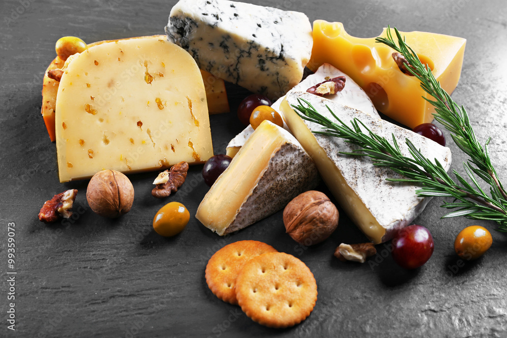 Composition of fresh cheese, fruits and vegetables on black background, close up