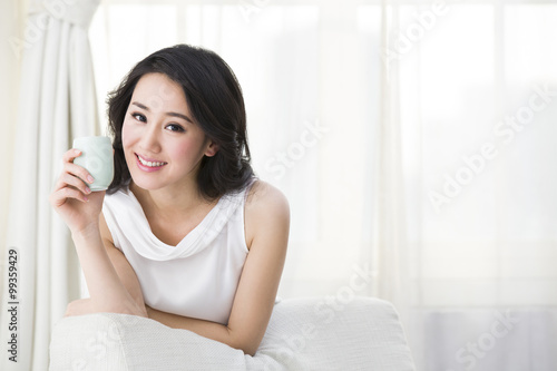 Free Download Happy young woman drinking tea - GFXLoad
