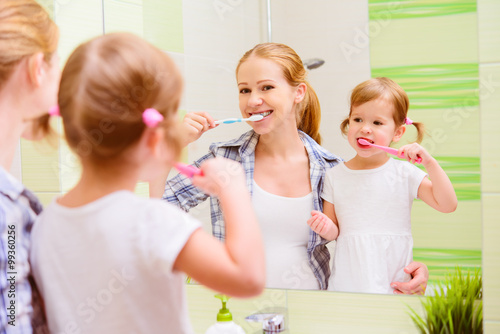 happy family mother and daughter child brushing her teeth toothb