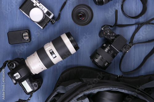 Photographer's equipment on a dark blue wooden background