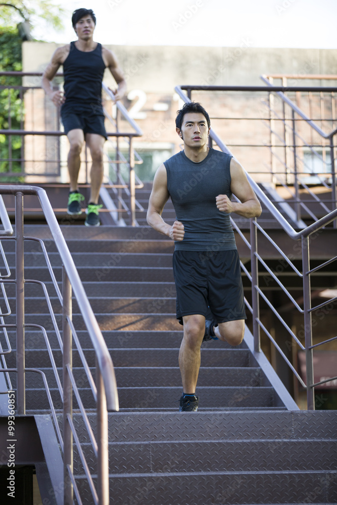 Young joggers running down steps Young joggers running down steps