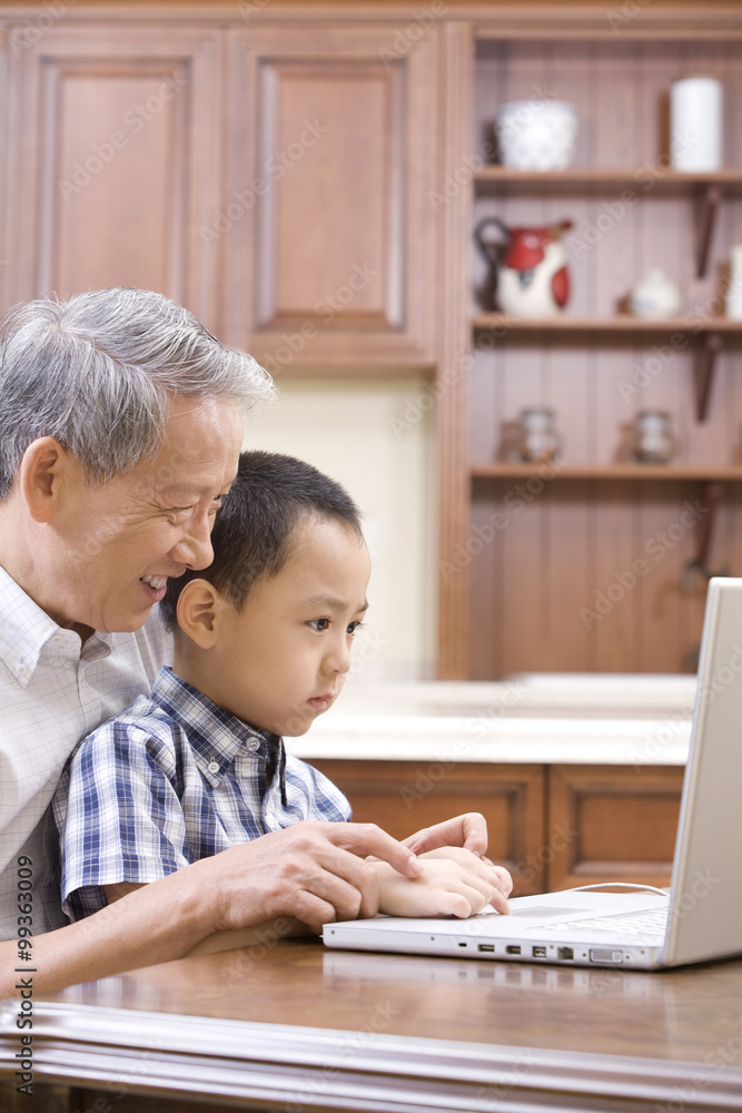 Grandfather and grandson using laptop Grandfather and grandson using laptop