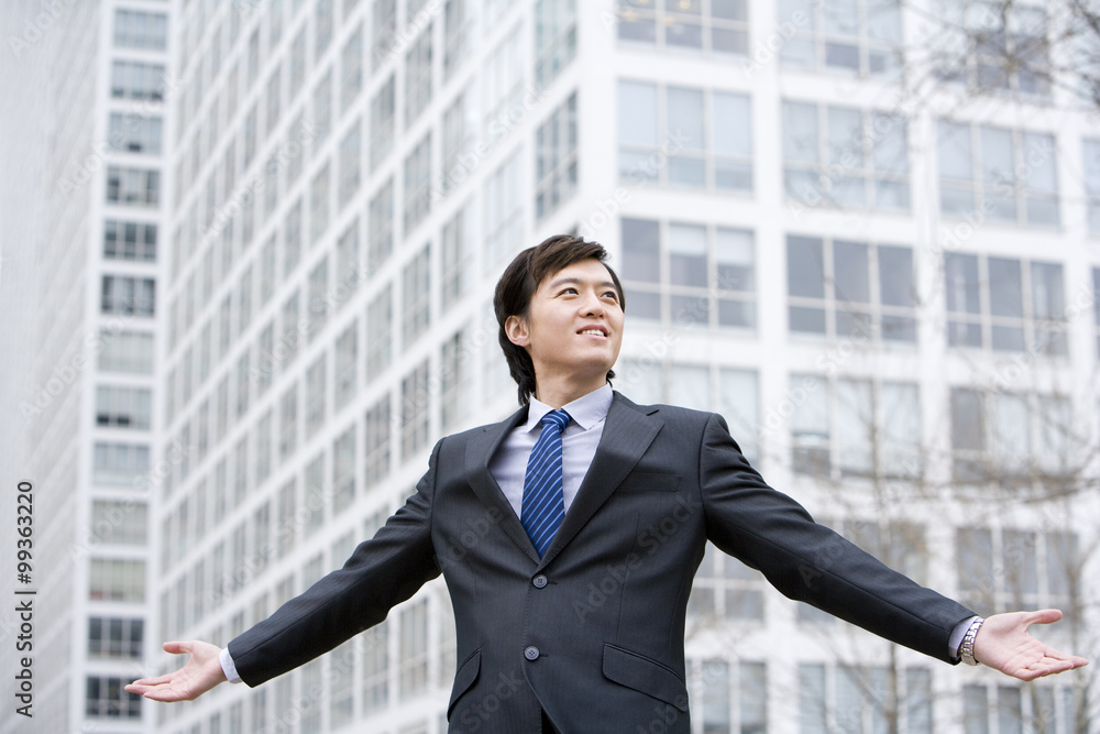 Businessman standing with arms outstretched Businessman standing with arms outstretched
