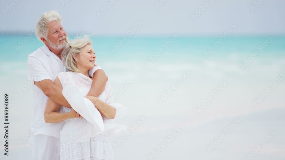 Happy Caucasian senior retired couple together on a tropical beach Happy Caucasian senior retired couple together on a tropical beach