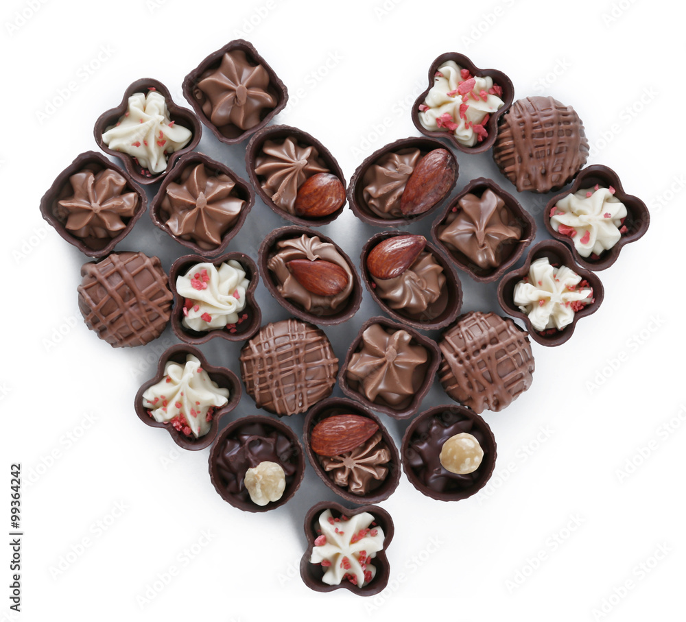 Heart shape composition of chocolate candies on white background Heart shape composition of chocolate candies on white background
