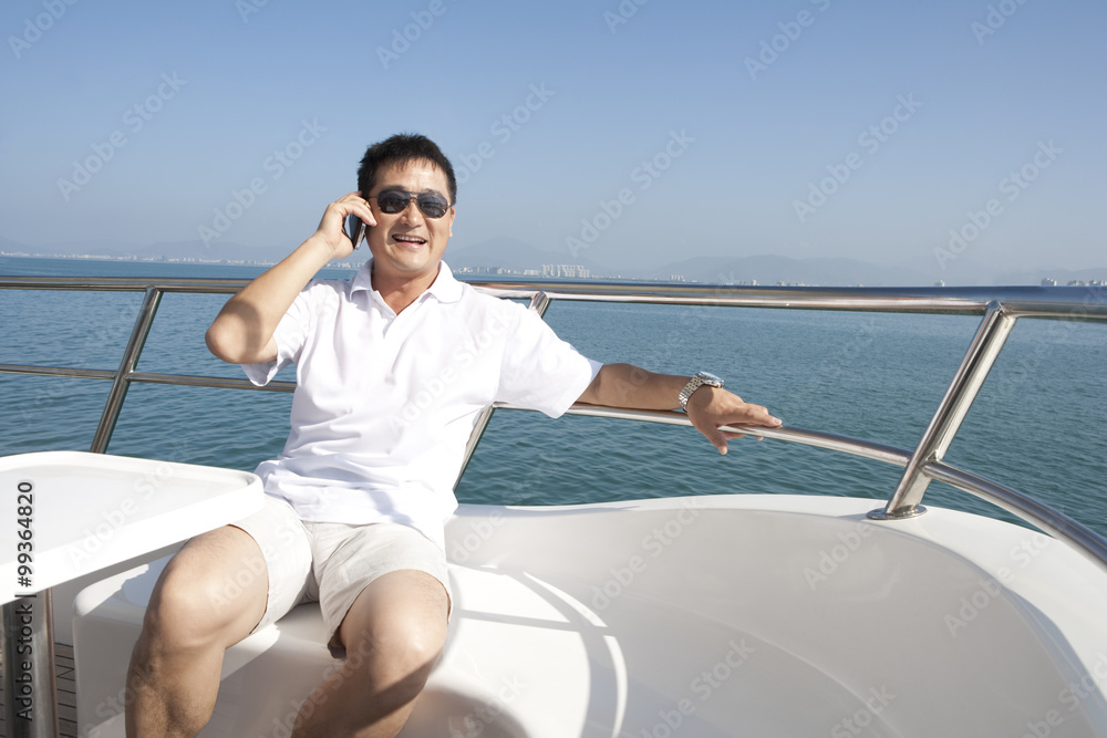 Carefree Man Talking on the Phone While Yachting