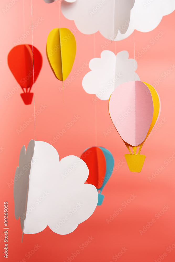 Paper clouds and airship on pink background