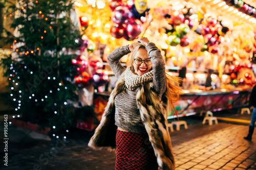 Photography Street portrait of smiling beautiful young woman on the festive Christmas fair