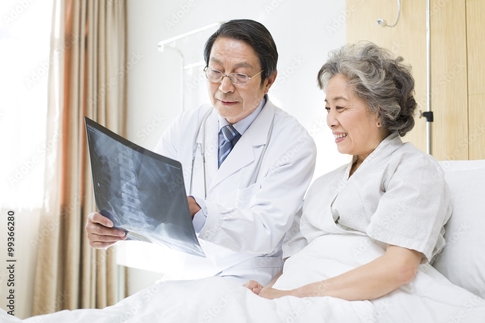 Doctor showing X-ray image to patient Doctor showing X-ray image to patient