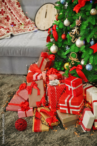 Christmas gifts under the fir tree in living room