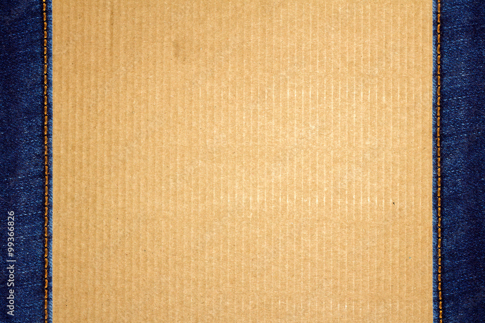 Fototapeta premium Frame of stitched blue jeans on cardboard