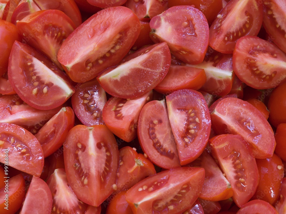Chopped tomatoes background. Riped red tomatoes prepared for cooking italian style food close up. Chopped tomatoes background. Riped red tomatoes prepared for cooking italian style food close up.